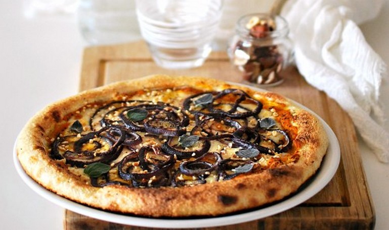 Home made pizza with pumpkin cream, caciocavallo cheese and red onion